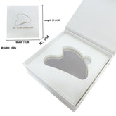 Heart-shaped gua sha tool in a white box with dimensions and weight information.